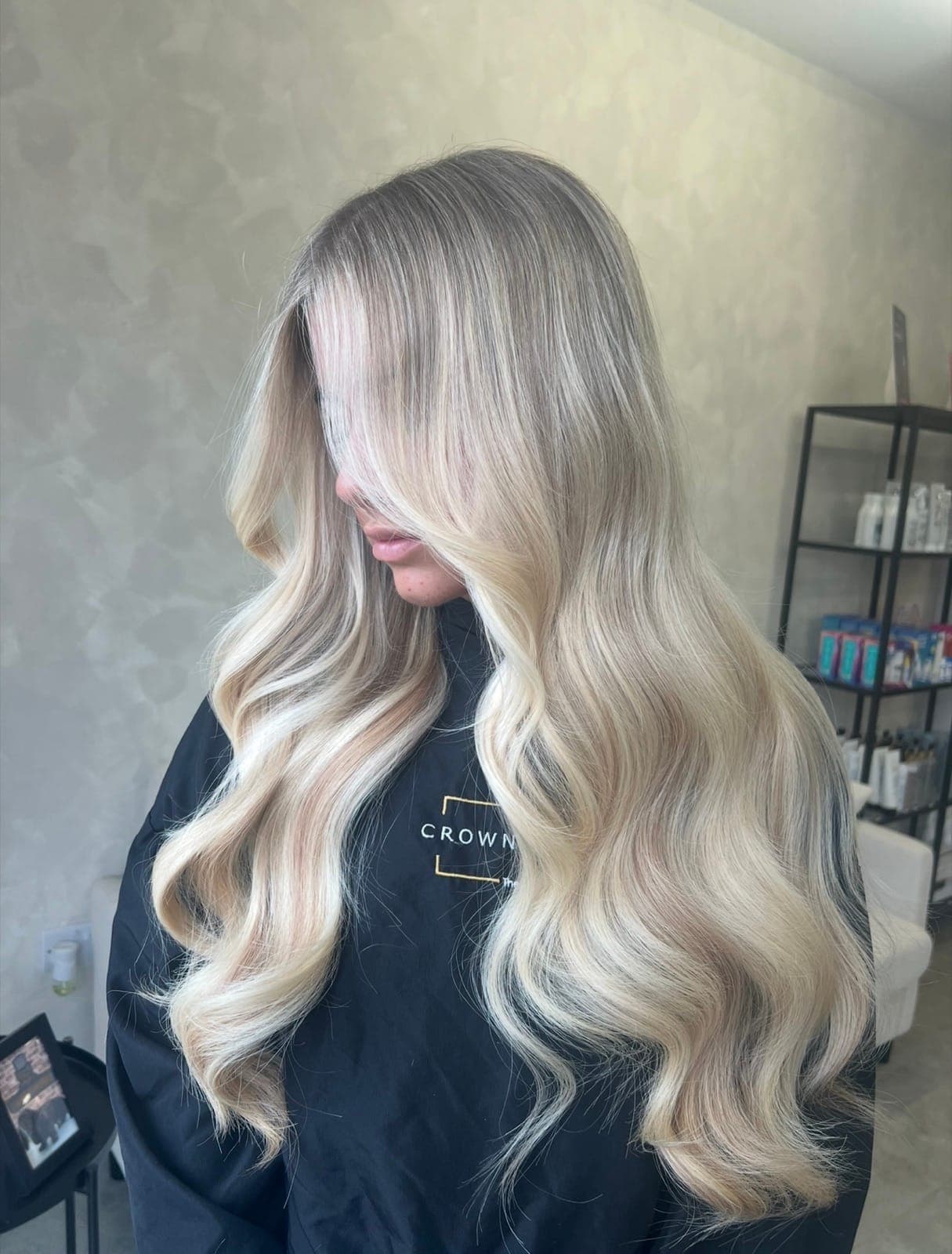 Long, bright blonde in soft waves with a cool, dimensional finish.
