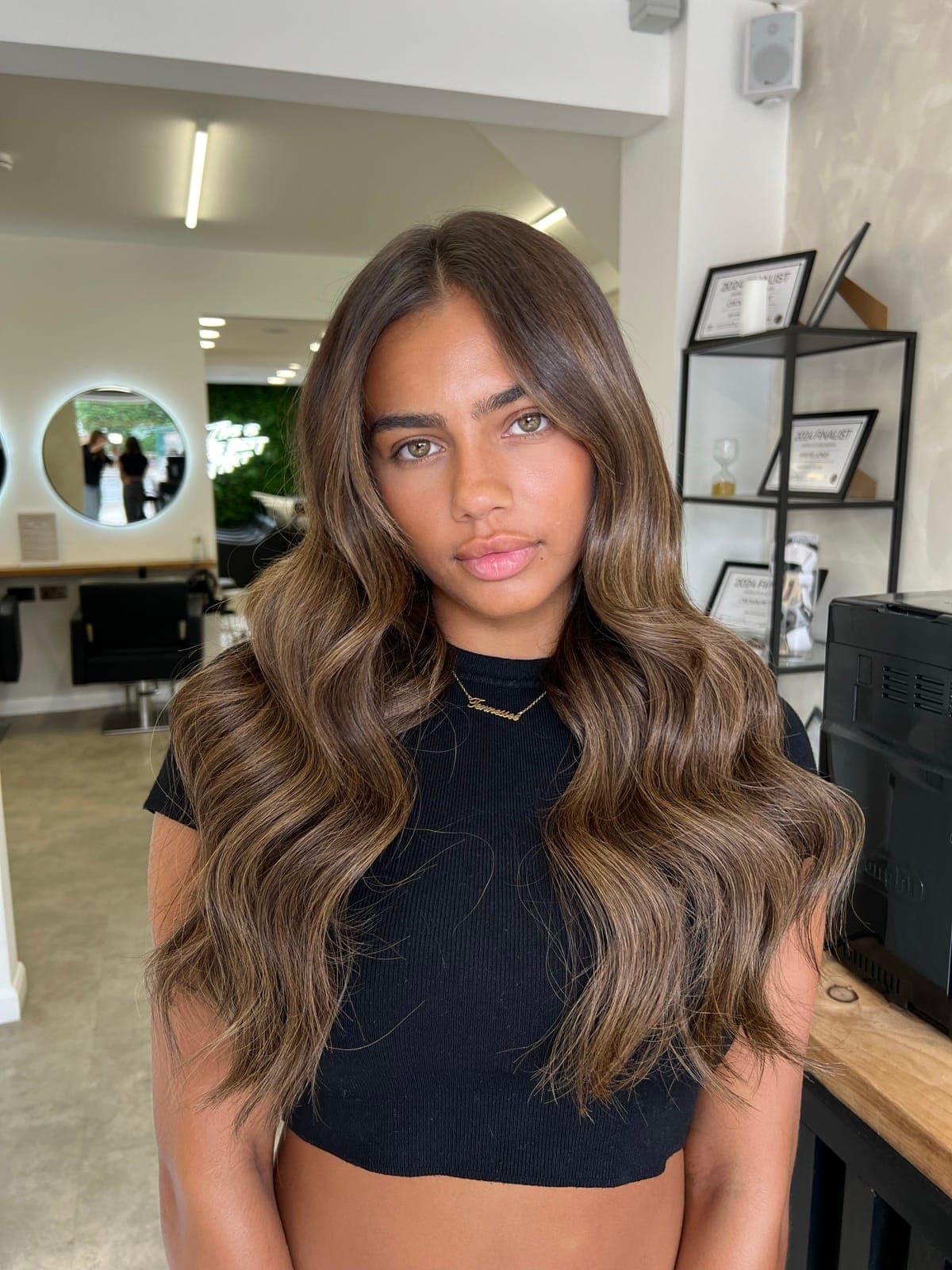 Long, wavy brunette with warmth and dimension through the mid-lengths and ends.