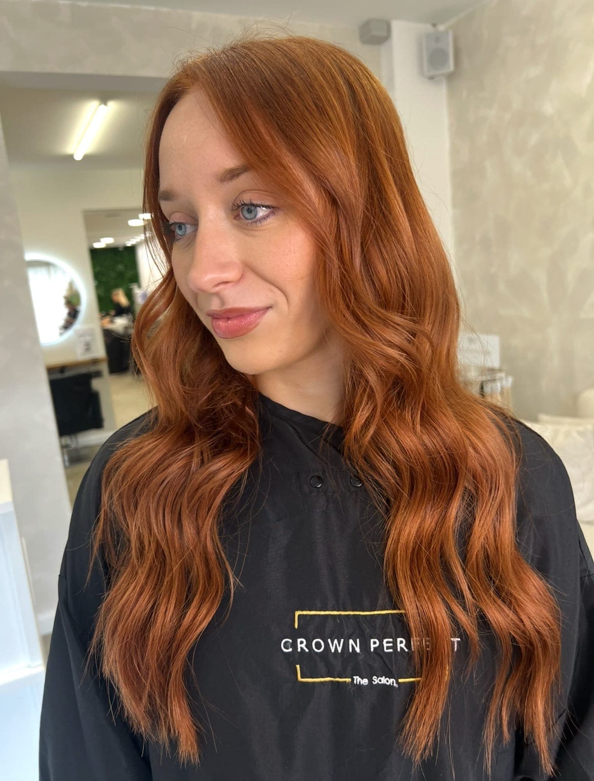 Long, warm copper hair in soft waves with a glossy finish.