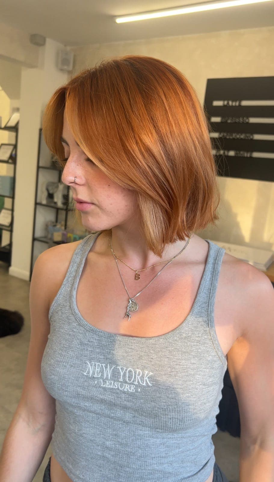A copper bob in a bright, glossy finish, worn just above the shoulder.