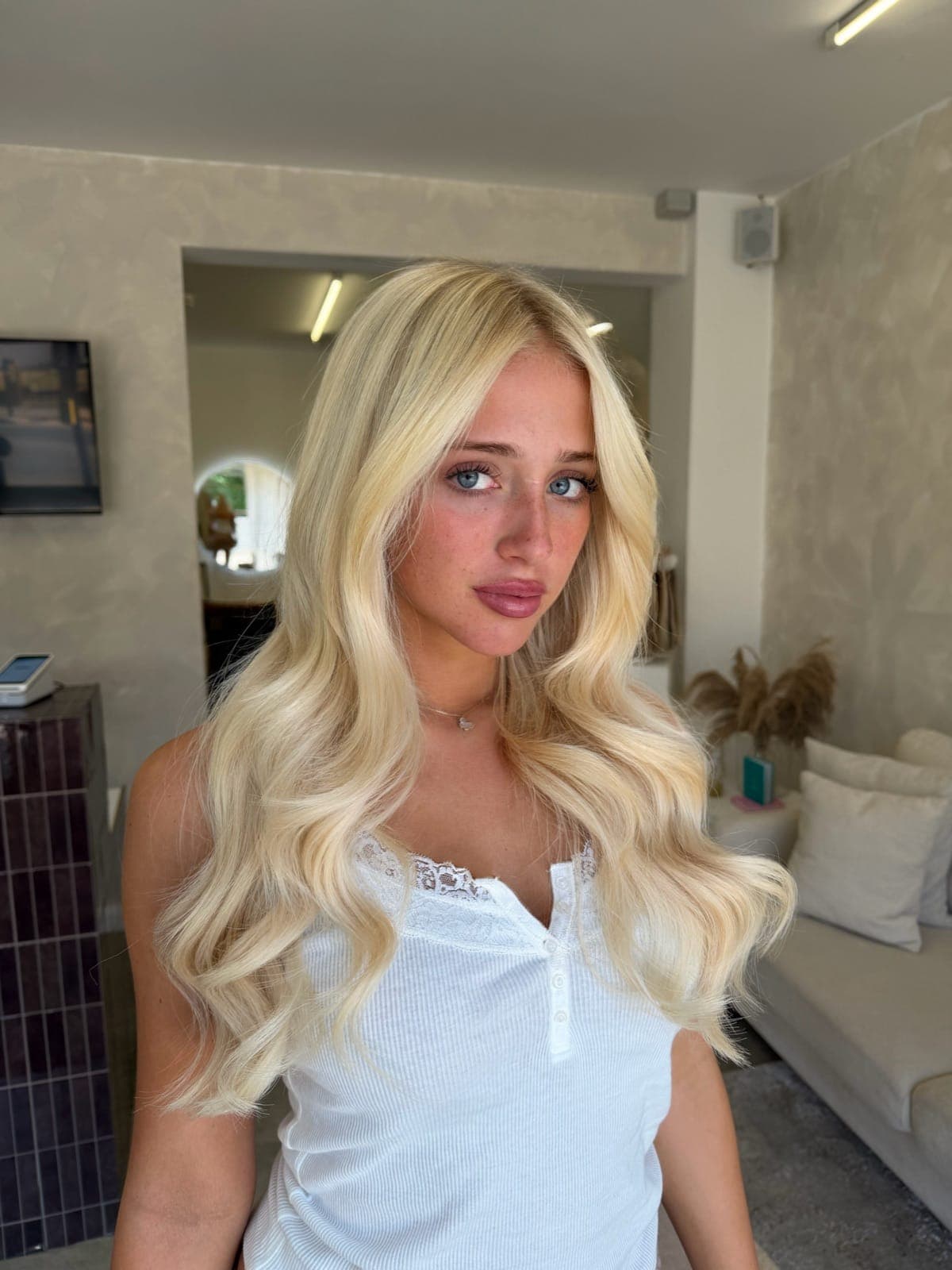 Long, voluminous blonde hair with extensions added for length and thickness, styled in soft waves, Crown Perfect, Surrey