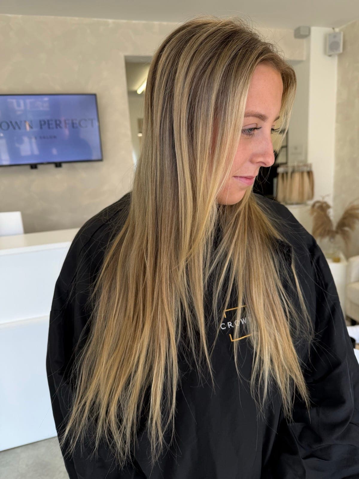 A grown-out blonde brightened into a cool, dimensional blonde with soft waves, before