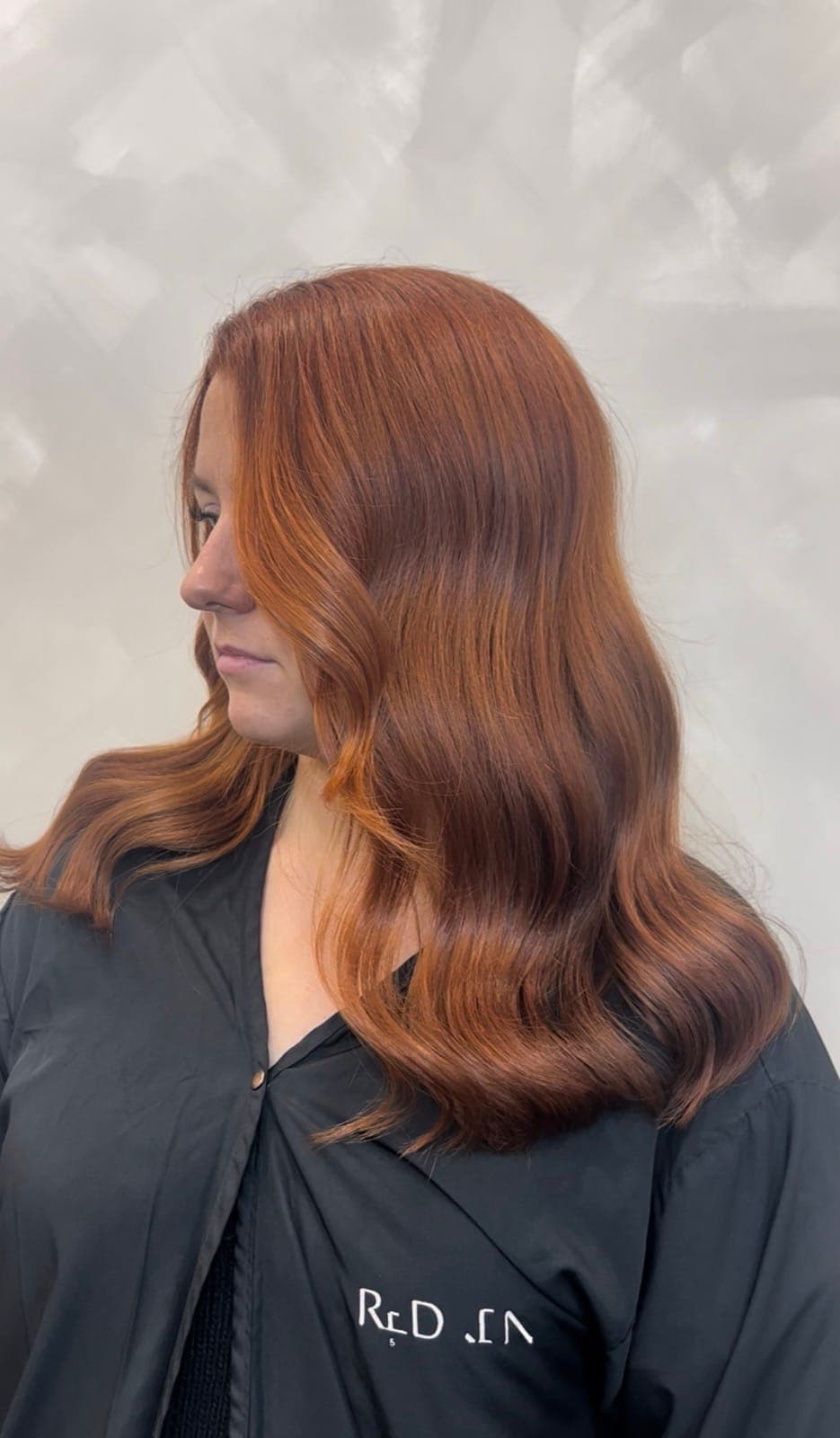 A copper transformation from dry, natural hair to a glossy, dimensional copper with soft waves, after
