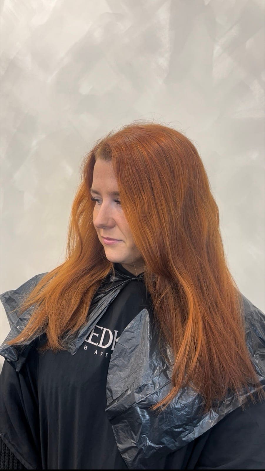 A copper transformation from dry, natural hair to a glossy, dimensional copper with soft waves, before