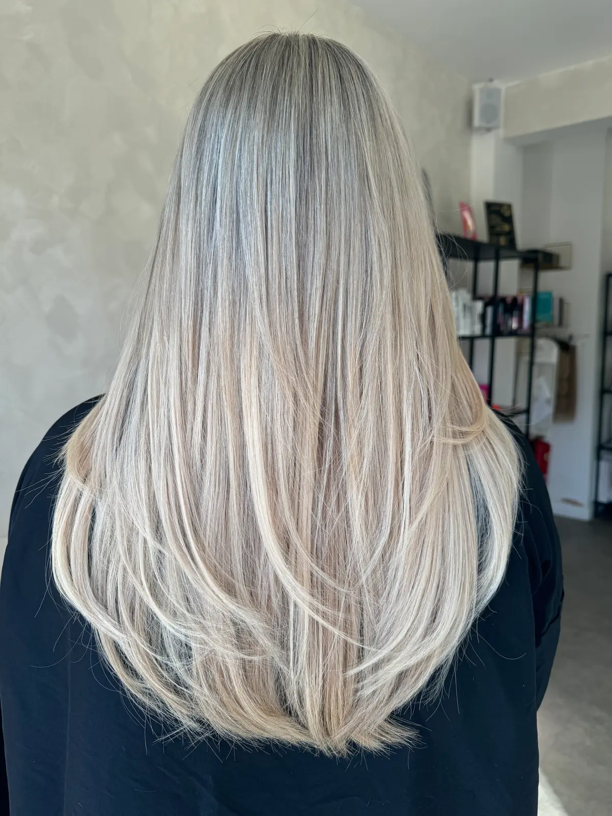Shoulder-length blonde hair made long and layered with tape extensions, seen from behind, Crown Perfect, Surrey, after