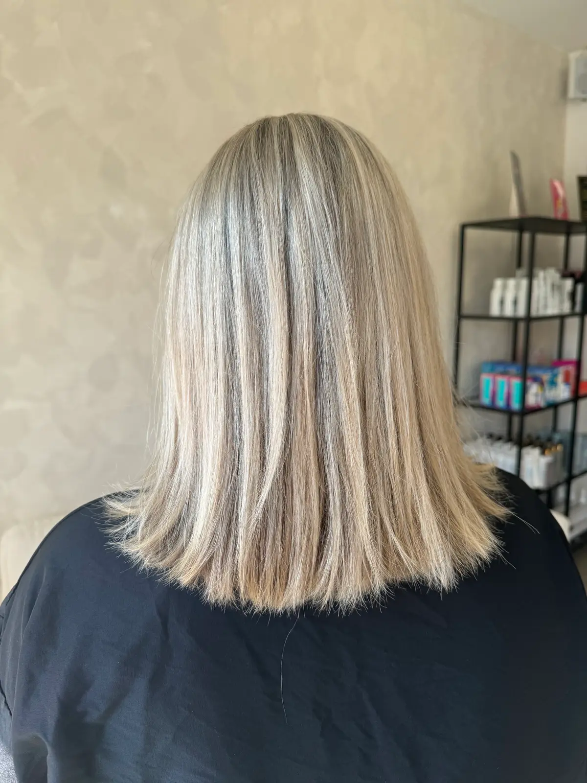 Shoulder-length blonde hair made long and layered with tape extensions, seen from behind, Crown Perfect, Surrey, before